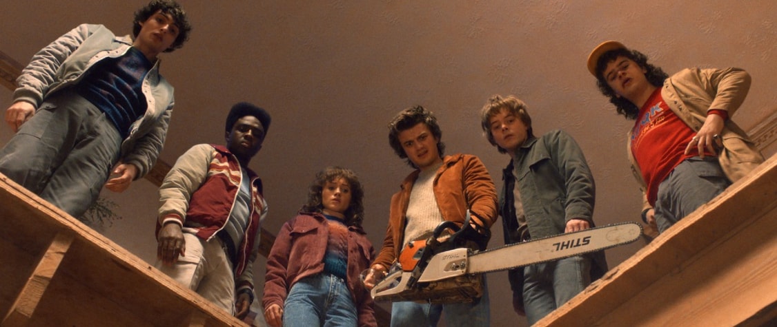 Mike, Lucas, Nancy, Steve, Jonathan, and Dustin of 'Stranger Thing' standing around a hole in the floor.