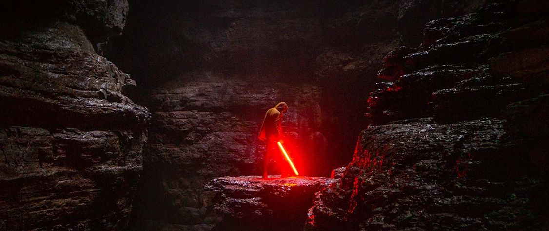 Man holding a red lightsaber