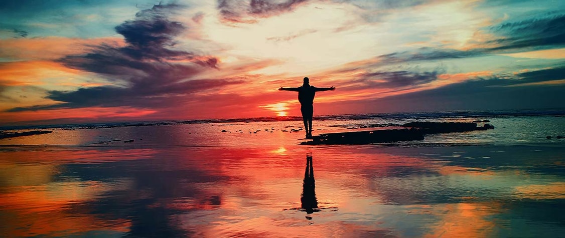 man on the beach at sunset
