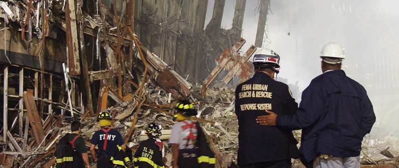 Photo of two first responders standing at the attack site.