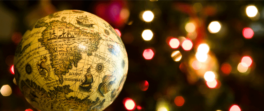 Photo of globe against background with Christmas lights.
