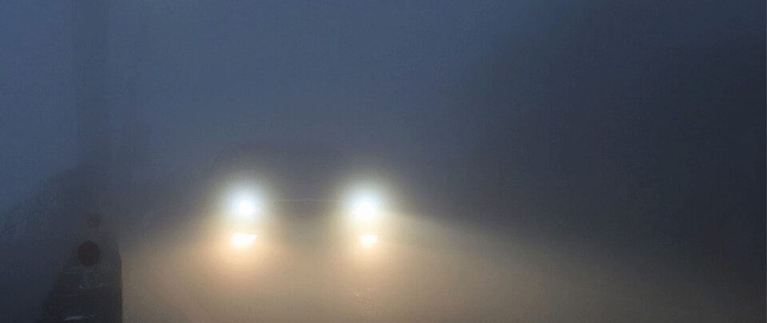Foggy photo of car's headlights.