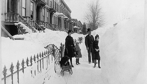 Photo of people on snow covered side walk in 1888 New York blizzard.