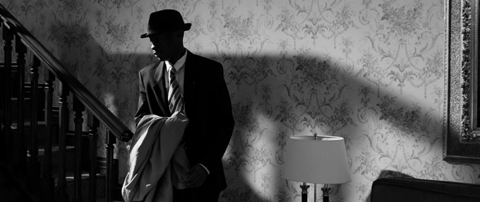 Image of spy against wall.