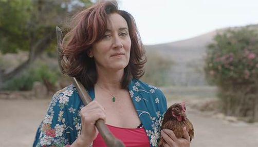 Still from "Recipes for Love and Murder" of a woman holding an axe