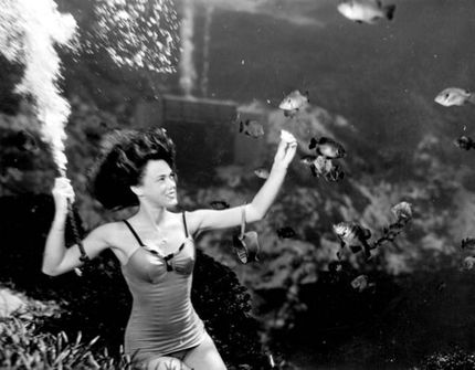 Frances Dwight feeding the fish as a part of the underwater show at Weeki Wachee Springs