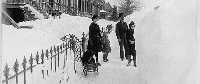 Worst-winters-in-history_feature Image of people on snow covered New York sideway during the Great Blizzard of 1888.