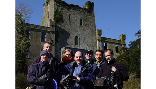 Modern day ghost hunters in front of a castle.
