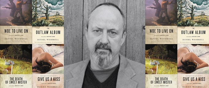 remembering-daniel-woodrell_feature Photo of Daniel Woodrell next to covers of his books.