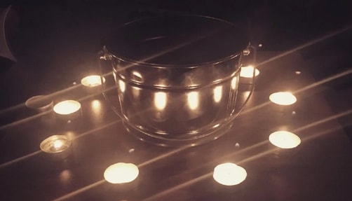 Ten lit candles in the dark.