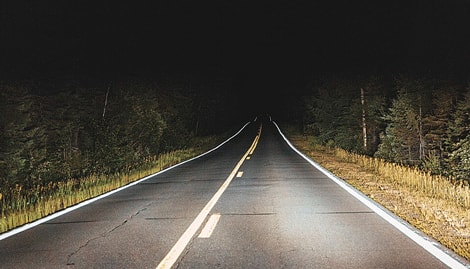 Photo of headlights driving in night.