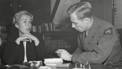 Mildred Gillars, better known as "Axis Sally" to American GIs, sits for an interview with an AP reporter in her cell.