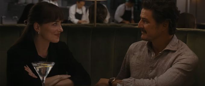 screenshot of materialists shows dakota johnson and pedro pascal at a restaurant