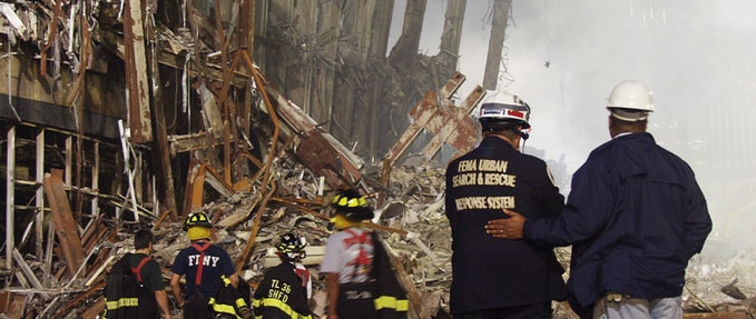 Photo of two first responders standing at the attack site.