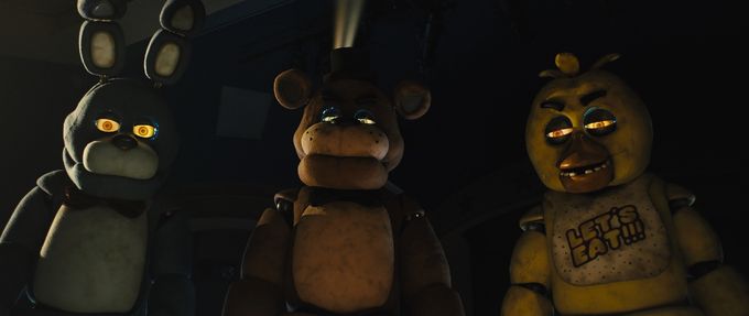 best-family-friendly-horror-movies_feature Three animatronics staring at the viewer in a still from the film 'Five Nights at Freddy's'