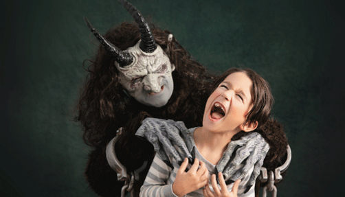 Krampus scaring a young child.