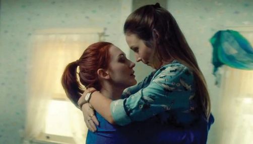 Two women, Waverly Earp and Nicole Haught, embrace in a still from 'Wynonna Earp.'