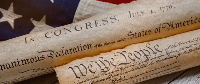 Photo of the Declaration of Independence on an American flag.