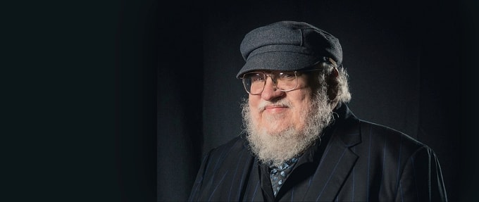 portrait of george rr martin against a gray background