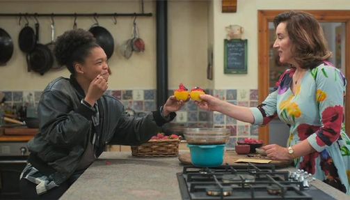 Still from "Recipes for Love and Murder" of two women clinking glasses