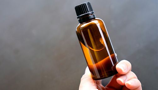 Hand holding a small bottle