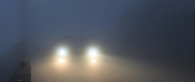 Foggy photo of car's headlights.