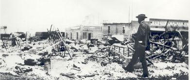photo of man walking through ruins