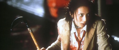 Still from 'Battle Royale' of boy holding weapon.