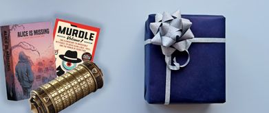 A card game, logic puzzle book, and codex displayed next to a wrapped blue present.