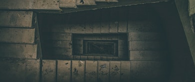 spiral stairs leading downward into the dark