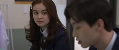 a girl looks at a boy in the screenshot of xo, kitty season 1