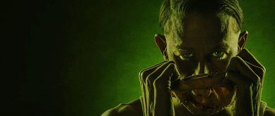 Charlie Hunnam as Ed Gein, pulling a mask off 