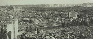 Men tour the wreckage of Lille, France during the German occupation of World War I.