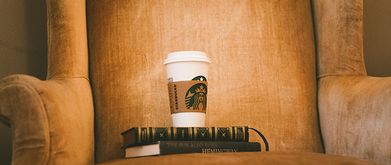 reading chair with books and coffee on it